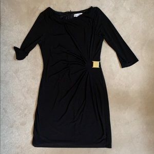 Black midi dress, gold buckle for slimming affect.
